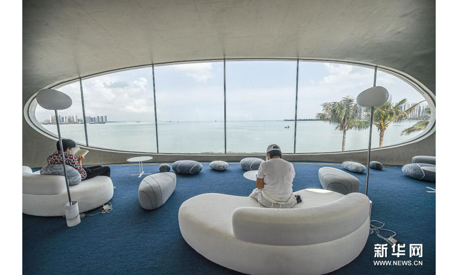 4月13日，游客在位于海口市海口湾的云洞图书馆内阅读、休憩。新华社记者 蒲晓旭 摄