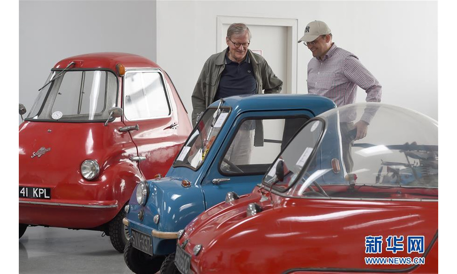 　　7月8日，两名男子在奥地利弗森多夫举行的“迷你”老爷车展上参观。新华社记者 郭晨 摄

