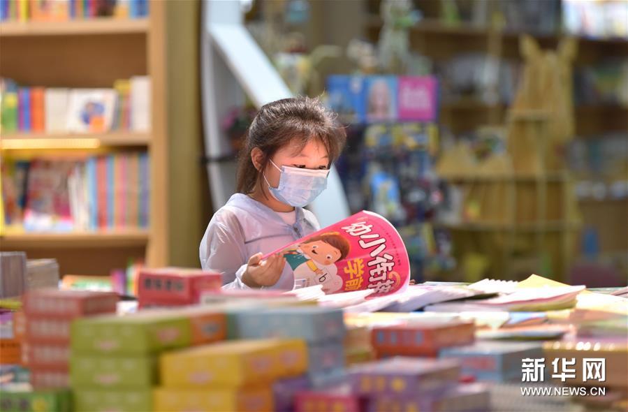 7月5日，一名小朋友在河北省定州市新华书店阅读图书。 新华社记者 朱旭东 摄