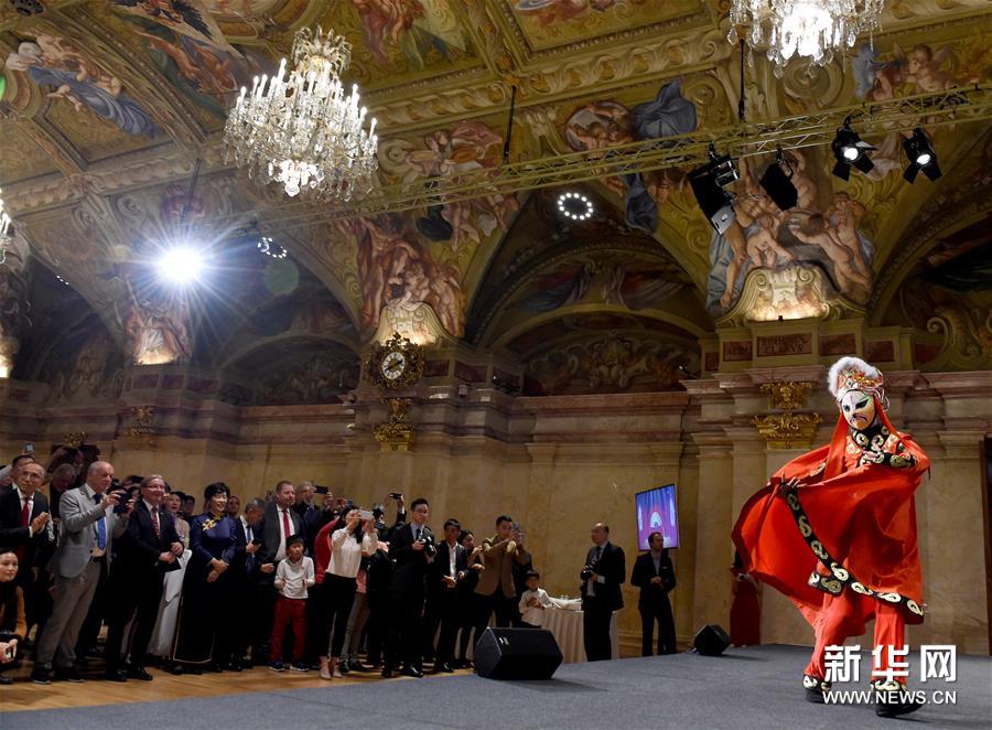 10月9日，在奥地利首都维也纳“文化中国、锦绣四川”四川文化旅游展示会上，人们观看“变脸”表演。9日晚，“文化中国、锦绣四川”四川文化旅游展示会在奥地利首都维也纳举办。本次活动通过图片展、传统文艺表演以及川菜美食推介等形式，向当地居民和海外华人展示川蜀文化，展现中国魅力，受到了一致好评。新华社记者 郭晨 摄
