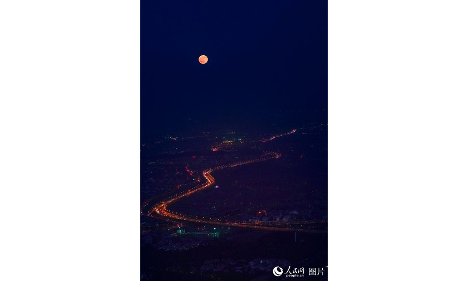 2019年12月12日，今年的最后一次满月如约登场。随着夕阳西下，满月逐渐从橙色转向白色升到空中，与夜晚的城市相互呼应，呈现出皓月当空的美丽景色。 王月博/摄