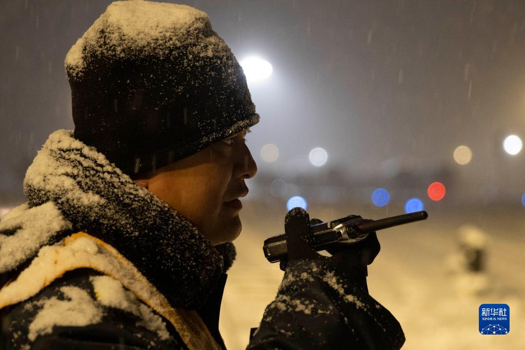 11月22日凌晨，在鸡西站西场，工作人员通过对讲机沟通清雪作业情况。

　　黑龙江省鸡西市气象局于11月22日03时50分将暴雪橙色预警信号升级为暴雪红色预警信号。为保障当地物资运输畅通、居民出行便利，鸡西市相关部门迅速组织除雪力量，一夜无眠的“逆行者”在暴雪中用自己的辛苦付出，保障城市有序运转和居民正常生活。

　　新华社记者 张涛 摄