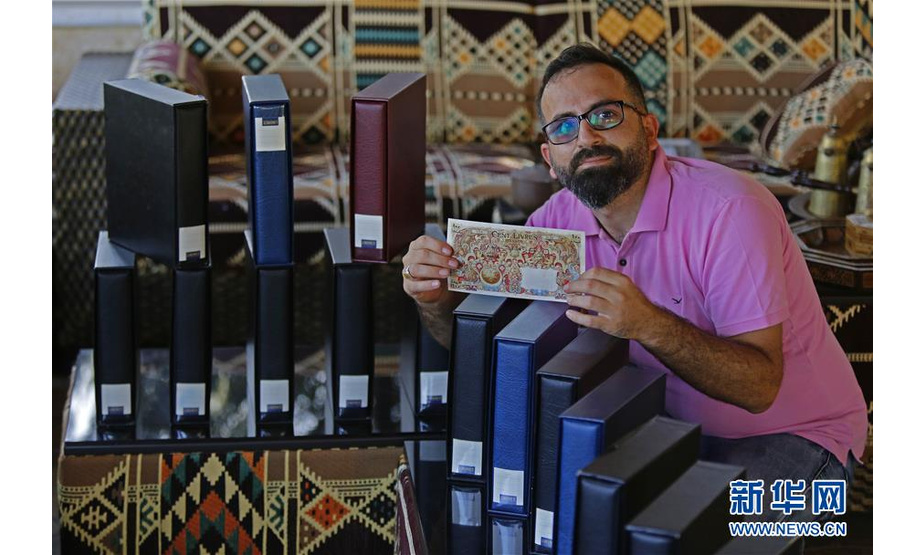 10月12日，黎巴嫩男子维萨姆·阿里·优素福在位于黎巴嫩南部舍格拉地区的家中展示其收藏的纸币。新华社发（比拉尔·贾维希摄）