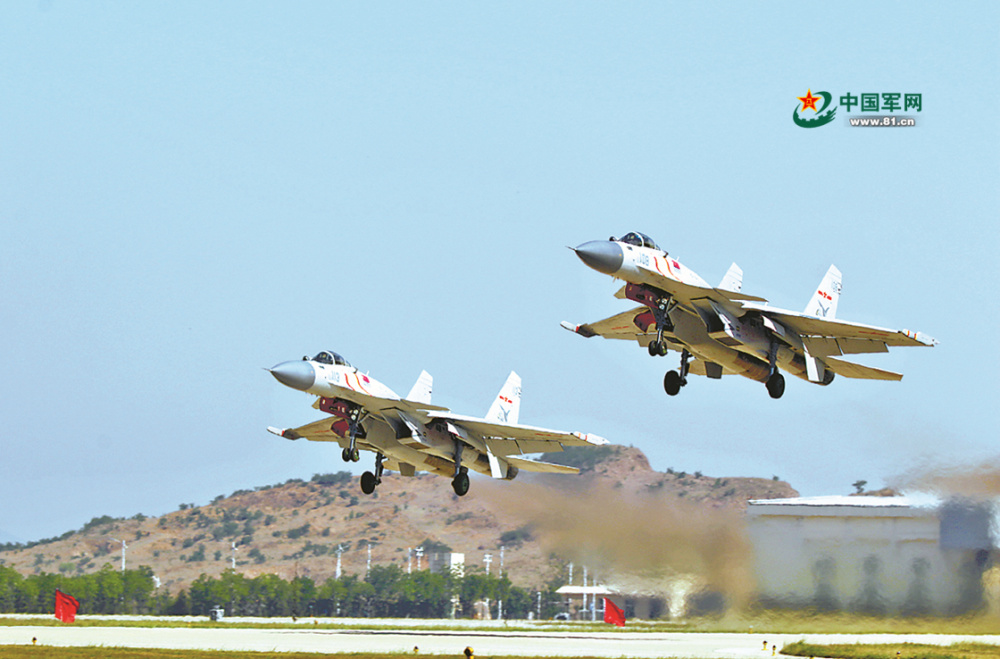 记者在现场了解到，歼-15舰载战斗机正在进行的这场空中加油训练，加油机和受油机均是同种型号的战机，因此称为“伙伴加油”。据介绍，“伙伴加油”的优势是加受油机性能接近，协同配合更默契，可以延长战机留空时间，让“飞鲨”越飞越远。“5米、3米、2米……”“对接！”两架歼-15舰载战斗机成功对接，开始进行空中加油。数分钟后，加油结束，战机迅速调整航线，展开空中拦截、近距空战等多个课目训练。图为轰鸣声中，两架“飞鲨”腾空而起，飞赴演训空域。