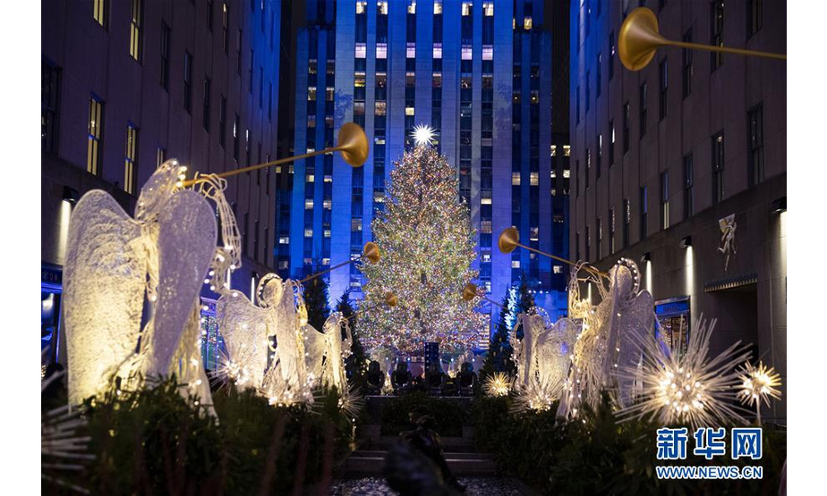 这是12月4日在美国纽约洛克菲勒中心拍摄的点亮后的圣诞树。 纽约洛克菲勒中心4日举行一年一度的圣诞树亮灯仪式，点亮一棵用超过50000个彩灯装饰的高约77英尺（约23.5米）的挪威云杉圣诞树。 新华社记者 王迎 摄