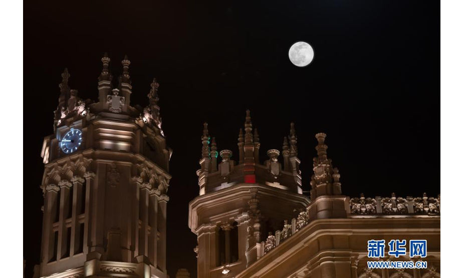 这是2月26日在西班牙马德里西贝莱斯宫上空拍摄的月亮。

　　新华社记者 孟鼎博 摄