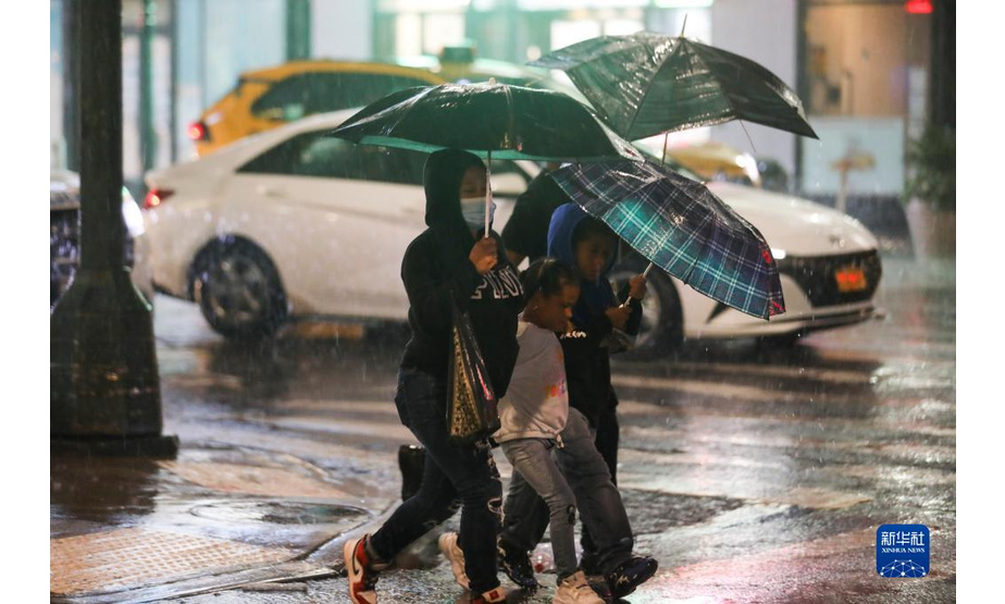 9月2日，人们冒雨走在美国纽约街头。

　　受飓风“艾达”影响，暴雨1日晚开始袭击纽约市及周边地区，并引发洪涝灾害。纽约州州长凯茜·霍楚尔于2日凌晨宣布该州进入紧急状态。

　　新华社记者 王迎 摄