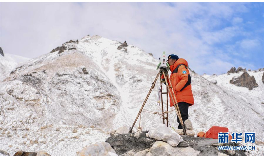 自然资源部第一大地测量队队员郑林在使用全站仪对珠峰峰顶进行交会观测（5月27日摄）。 当日，2020珠峰高程测量登山队成功登顶后，在珠峰大本营的珠峰高程起算点，自然资源部第一大地测量队队员利用全站仪等仪器对珠穆朗玛峰峰顶进行交会观测。 新华社记者 普布扎西 摄