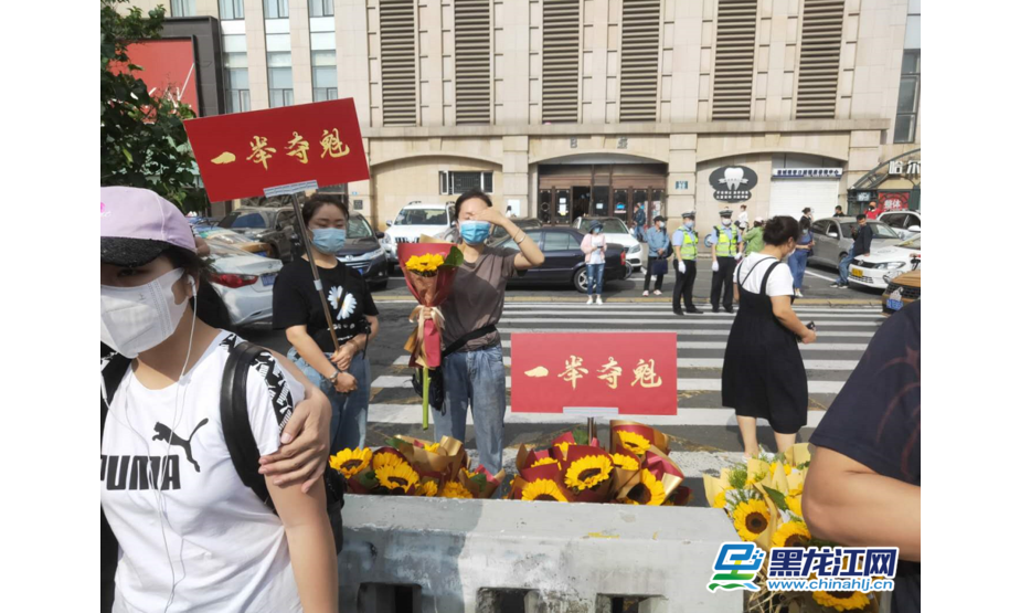 哈尔滨第一中学考点现场很多家长都购买向日葵，来预祝自己的孩子能够“一举夺魁”。