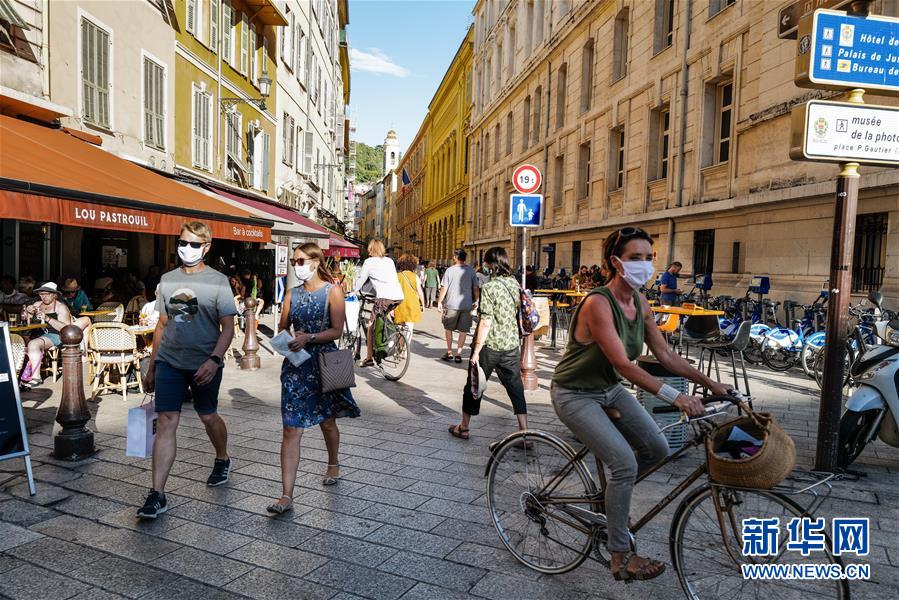 8月4日，人们在法国尼斯市中心佩戴口罩出行。 由于疫情反弹，法国南部海滨城市尼斯自3日起强制民众在部分室外公共场所佩戴口罩。 新华社发（塞尔日·阿乌齐摄）