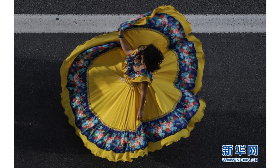 7月21日，在巴西圣保罗市，舞者在保利斯塔大街上表演。新华社发（拉赫尔·帕特拉索摄）