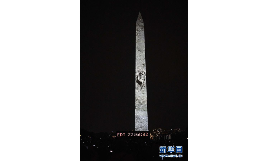 7月20日，在美国首都华盛顿，宇航员阿姆斯特朗在月球上的脚印影像被投射到方尖碑上。新华社记者 刘杰 摄