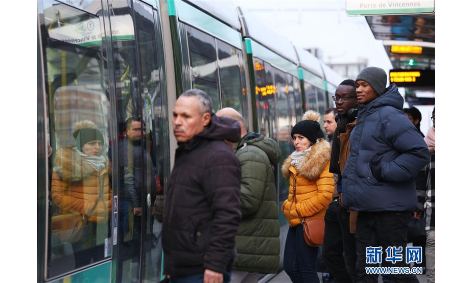 12月10日，在法国巴黎，人们在有轨电车站等车，为躲避罢工期间晚高峰的窘境，很多市民选择提前下班或者错峰出行。法国全国跨行业大罢工及游行10日继续举行，交通、教育等多个行业受到影响。新华社记者 高静 摄
