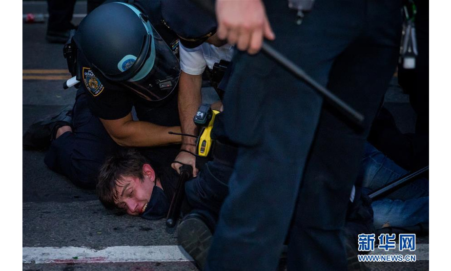 5月30日，在美国纽约布鲁克林，警察逮捕一名抗议者。 新华社发 （郭克摄）