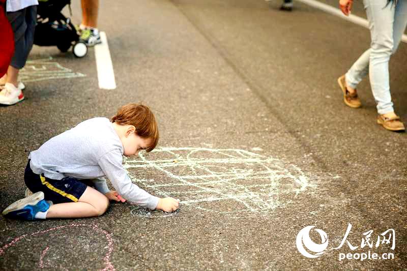 人民网纽约6月13日电 6月12日，纽约迎来第40届“第五大道博物馆节”。当晚，包括大都会博物馆、古根海姆博物馆等7家博物馆免费向公众开放。第五大道上东区指定路段禁止机动车通行，沿街有很多艺术表演和街头杂耍，小朋友们甚至可以以大街为画布，用彩色粉笔画出自己喜欢的图画，成了孩子们接受艺术启萌和玩耍的天堂。李立言摄