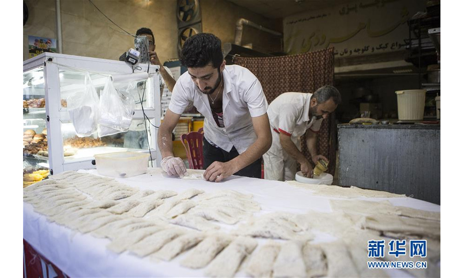 　5月18日，在伊朗北部马赞达兰省，商贩制作传统食物。 新华社发（艾哈迈德·哈拉比萨斯摄）