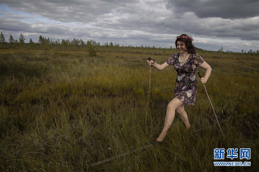 8月10日，在芬兰北部的普达斯耶尔维，一名女子参加“花裙高跟鞋 滑越沼泽地”趣味赛事。 在芬兰北部的普达斯耶尔维举行的“花裙高跟鞋 滑越沼泽地”趣味赛事已有14年的历史，参赛者要穿着花裙和高跟鞋，脚踩滑雪板滑行穿过30米的沼泽地带。相对于冬天在雪地上滑雪，夏日里在沼泽地滑行需要耗费更多的体力并掌握更多技巧，参与者也从中享受到了别样的乐趣。 新华社发（马蒂·马蒂凯宁摄）