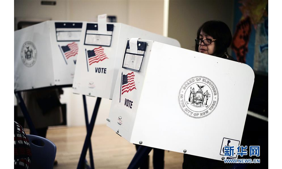 11月6日，在美国纽约曼哈顿，一名选民在一处投票站填写选票。 当日，美国迎来2018年中期选举投票日。新华社记者李木子摄