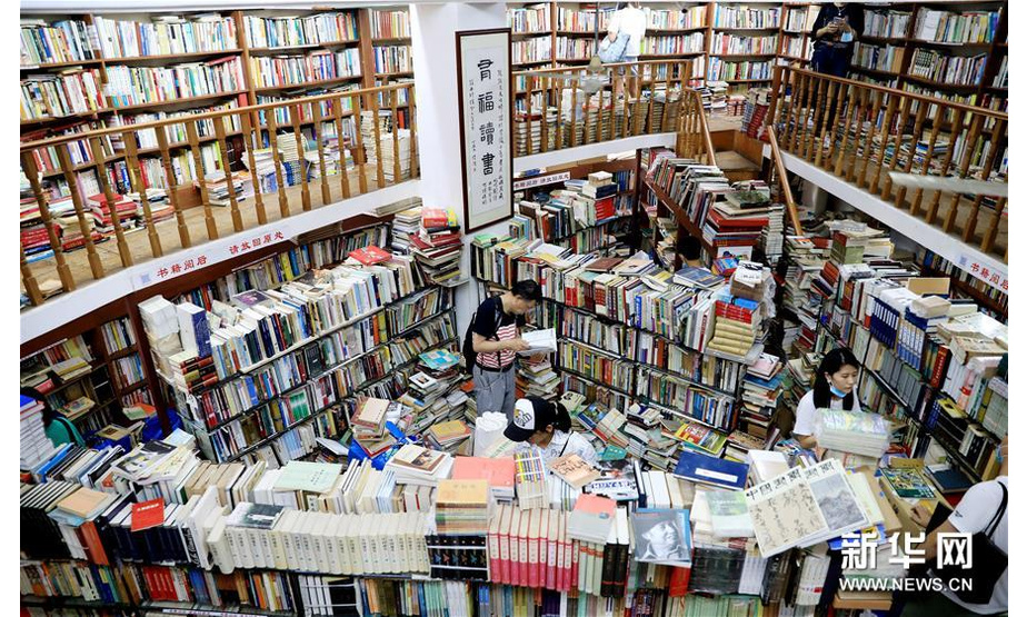 7月13日，读者在复旦旧书店内挑选书籍。新华社记者 方喆 摄