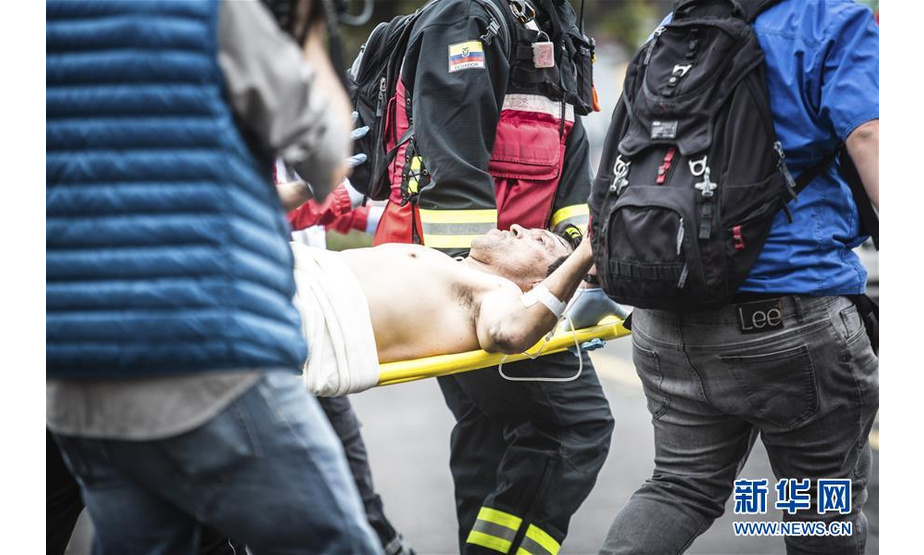 10月12日，在厄瓜多尔首都基多，一名受伤者被担架抬走救治。 新华社发